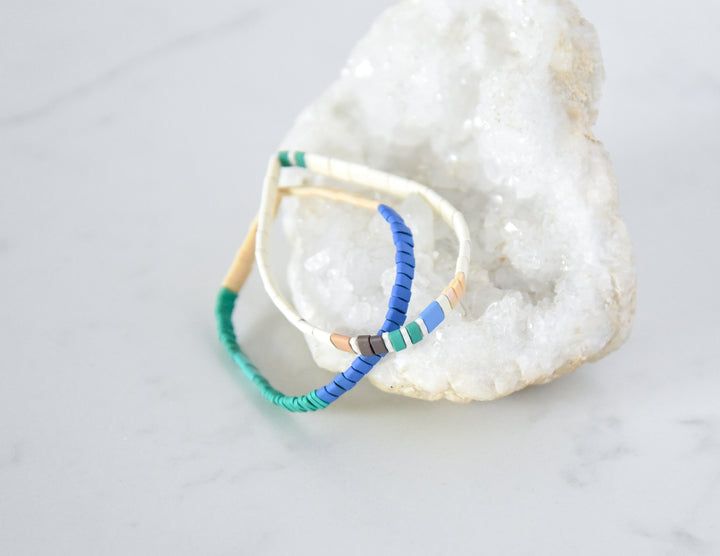 Vibrant SANTA CRUZ bracelet stack on white crystal featuring colorful beads | Current