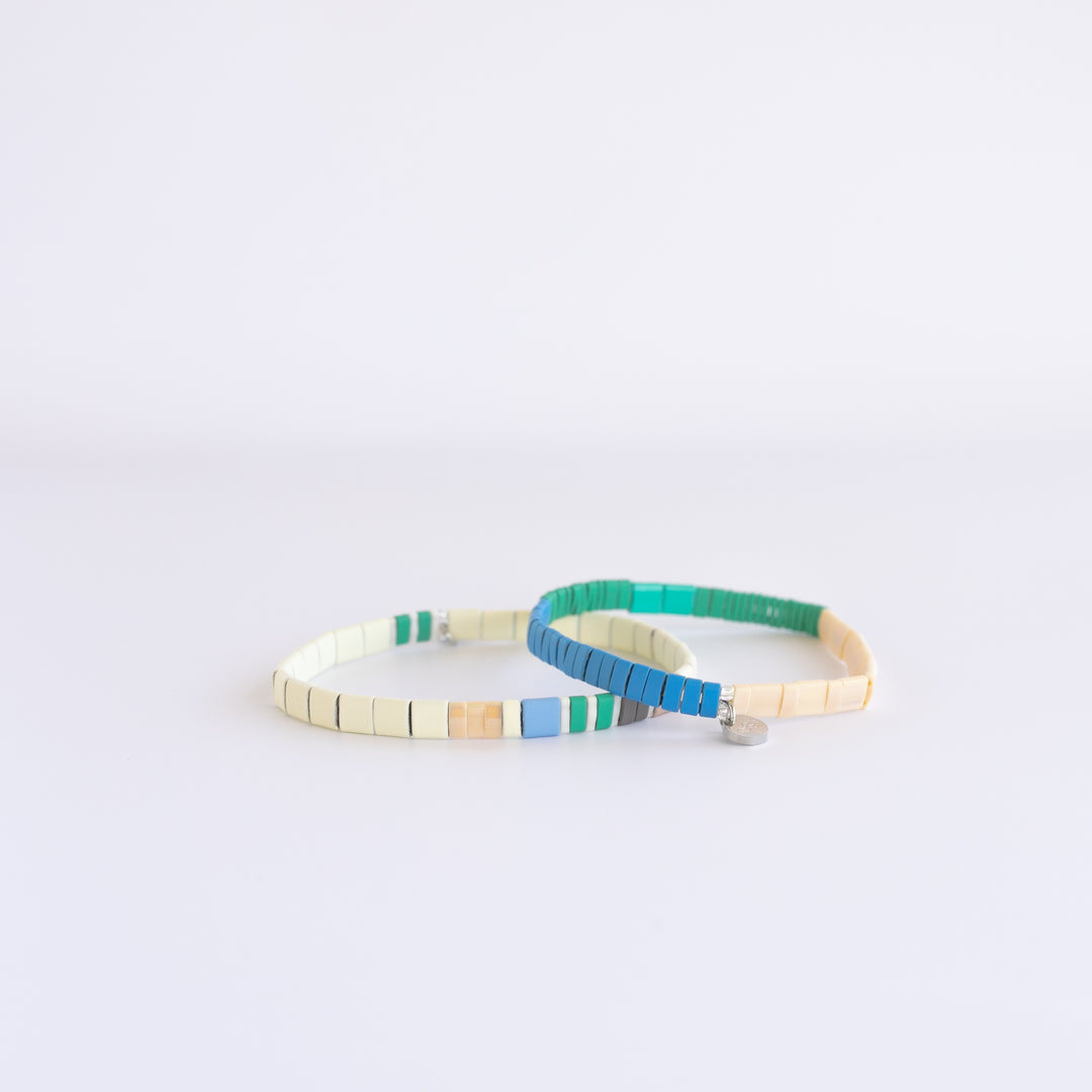 Vibrant SANTA CRUZ bracelet stack on white crystal featuring colorful beads | Current