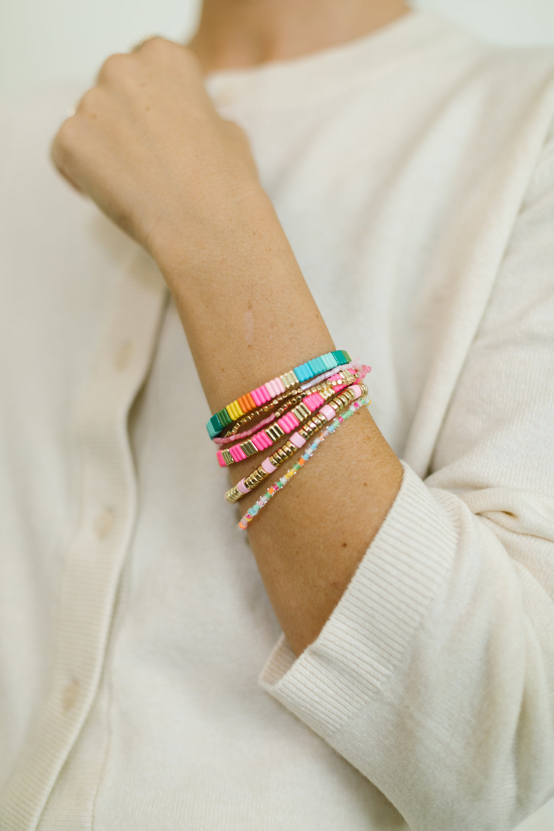 Add some color to your holiday with our Merry and Bright bracelet stack. A mix of Neon colors and gold, with pastel beaded bracelets.