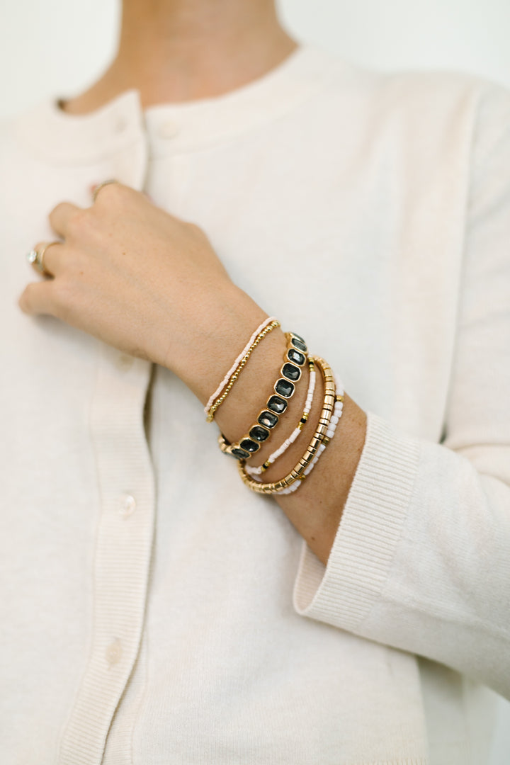 Ash accent bracelet in grey gems, gold, and white stone stretch bracelets.