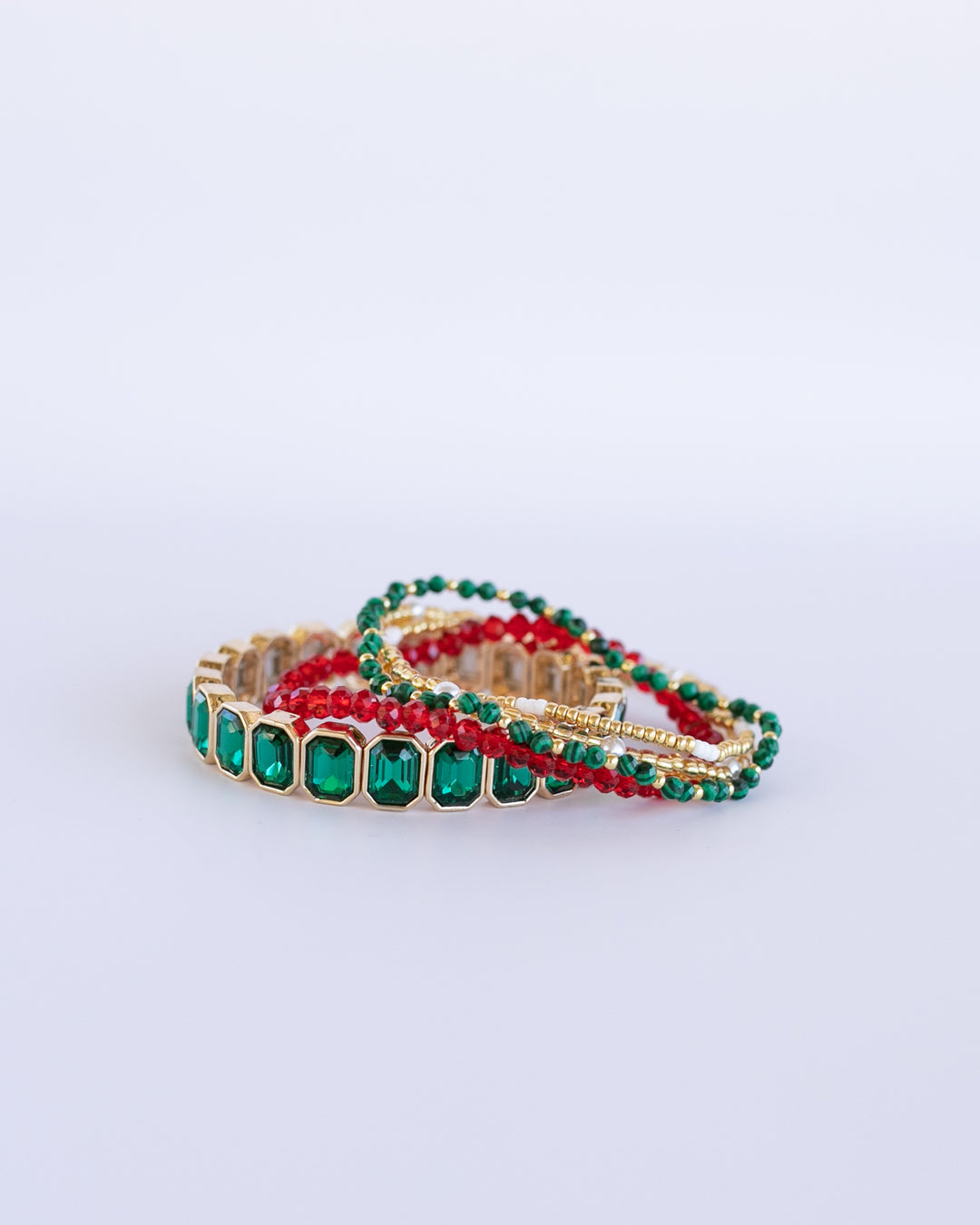 EVERGREEN BRACELET STACK -includes a vibrant emerald gem stretch bracelet, paired with dainty pearl, evergreen, and ruby gem bracelets.