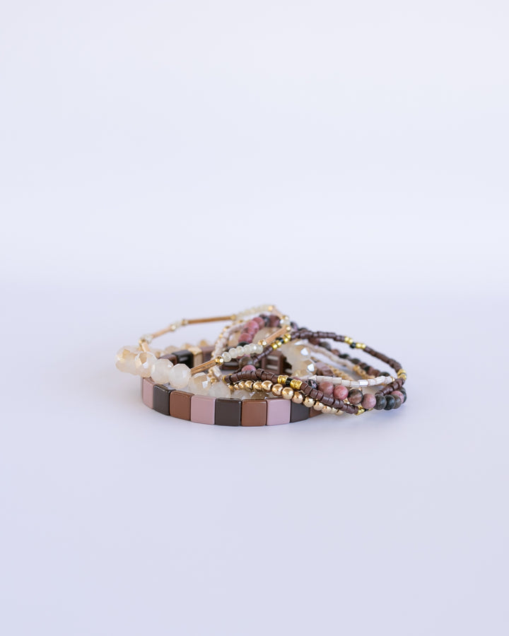 CRANBERRY BRACELET STACK. BOHO bracelets in beautiful earth tones, d with brown, MAUVE and gold accents. Paired with sparkling white jade bracelets