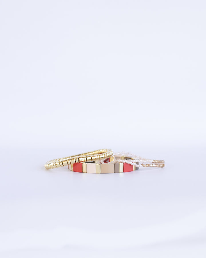 RED CHUNKY MONOCHROME Bracelet stack with red and soft neutral colors paired with gold enamel bracelet 